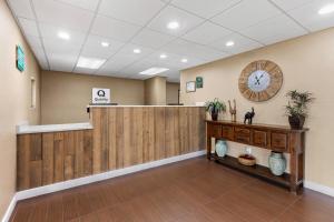 a waiting room with a clock on the wall at Quality Inn Kinston Hwy 70 in Kinston +47 photos