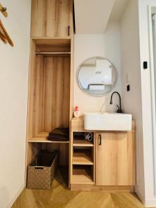 a bathroom with a sink and a mirror at Guest house雅 in Matsudo