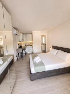 a bedroom with a large bed with towels on it at Pareti di mare in Capoliveri