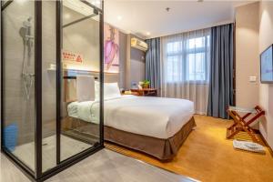 a hotel room with a large bed and a shower at Uniton Hotel Shenzhen in Shenzhen