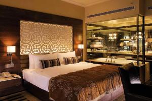 a bedroom with a large bed and a bath tub at Hotel Donland in Gwalior