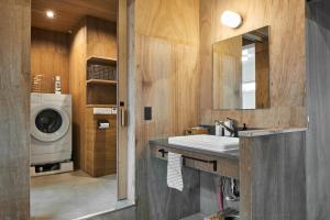 a bathroom with a sink and a washing machine at Nem Kumano by WhyKumano in Nachikatsuura