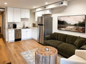 a living room with a couch and a kitchen at The Riverwood Retreat in St. Charles