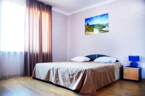 a bedroom with a bed and a large window at Autopapa in Rustavi