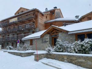a house with snow on the ground in front of it at C03 lajoue in Le Dévoluy
