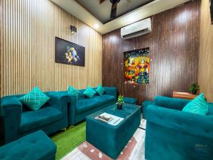 a living room with blue couches at Hotel Banke Bihari Dham in Vrindāvan