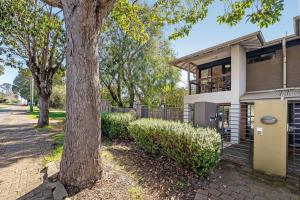 a tree in front of a house at Apartment 46 - Town Central - Close to Walktrails in Margaret River Town