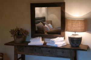 a mirror sitting on top of a table with towels at Romantikhütte Rothaarsteig in Schmallenberg +19 photos