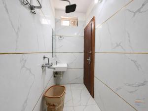 a bathroom with a sink and a toilet at Hotel Banke Bihari Dham in Vrindāvan