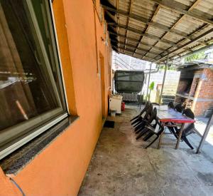 a patio with a table and chairs next to a building at MiR in Londža