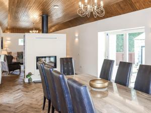 a dining room with a table and chairs and a fireplace at The Coach House in Auchtermuchty +17 photos