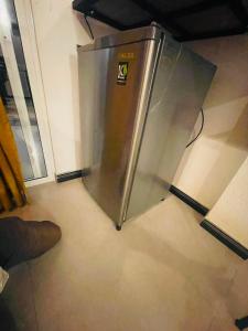 a stainless steel refrigerator sitting in a kitchen at Rainforest River Cabana & Villa in Deniyaya