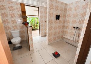 a bathroom with a toilet and a walk in shower at PK 35 in Apomaoro +64 photos
