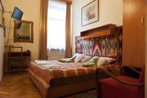 una camera da letto con un letto in una stanza con una finestra di Hotel Alef a Cracovia