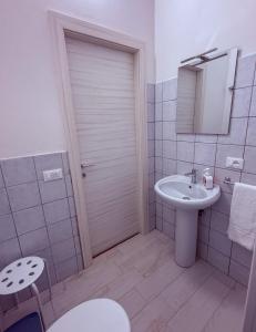 a white bathroom with a sink and a toilet at Marescià Siculiana Marina in Siculiana +13 photos