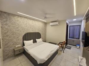 a bedroom with a bed and a television in it at Hotel Shiv Inn in Himatnagar