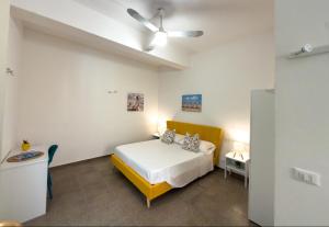 a bedroom with a bed and a ceiling fan at Marescià Siculiana Marina in Siculiana