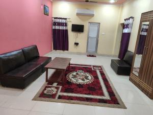 a living room with a couch and a table at Bindwasini Hotel And Party Palace in Bīrganj
