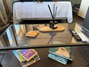 a glass table with a remote control on top of it at The Athenian Pearl in Athens +16 photos