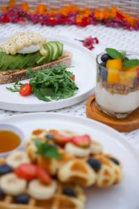 a table with three plates of food on plates at Uma Jineng Villa in Munggu +1 photo