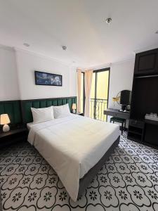 a bedroom with a large bed and a television at Hanoi Citadel Corner in Hanoi