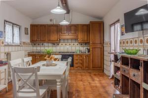 a kitchen with wooden cabinets and a table and chairs at Residenza Paradisea in Arezzo