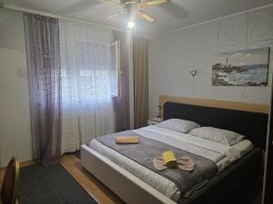 a bedroom with a bed with two towels on it at Vila Marija Rooms in Zagreb