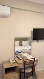 a room with a desk with a computer and a bed at Kenedi Otel in Altındağ