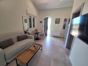a living room with a couch and a table at Resort Finikas in Alexandroupoli
