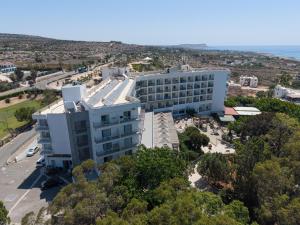 an aerial view of a building with the ocean in the background at Marina Hotel in Ayia Napa