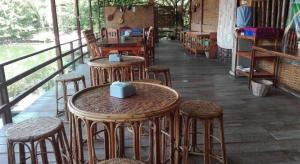 a row of tables and stools in a restaurant at Phu Resort in Ban Choko +195 photos