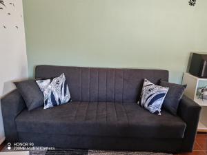 a couch with two pillows on it in a living room at Villa Luisa Torres in Argozelo