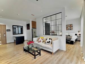 a living room with a couch and a table at Jazz Living - Tropical Apartment 5 minutes walk from landmark 81 in Ho Chi Minh City