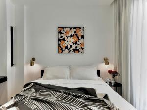 a white bedroom with a zebra blanket on a bed at Jazz Living - Tropical Apartment 5 minutes walk from landmark 81 in Ho Chi Minh City