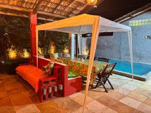 a bedroom with a canopy bed and a table at Casa Alemao Águas Belas in Cascavel +11 photos