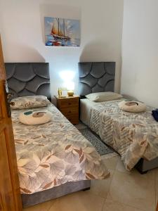 a bedroom with two beds and a sailboat on the wall at Najam café in Saïdia