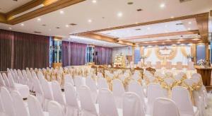 a banquet hall with white chairs and a table at Wangtai Hotel in Suratthani +291 photos