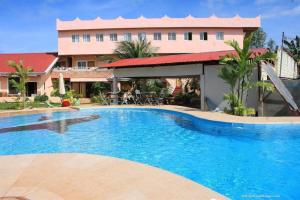 a large swimming pool in front of a building at Cocomango's Resort in Taporok +77 photos