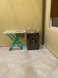 a washing machine in a room with a table at Najam café in Saïdia +4 photos