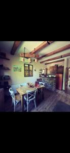 a room with a table and chairs and a kitchen at Etno kuća Todorović in Smederevo +32 photos