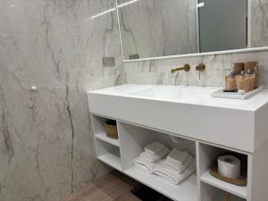 a bathroom with a white sink and a mirror at White Rose Athens Residence in Athens +31 photos