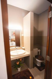 a bathroom with a sink and a toilet at Beachfront Bliss Ocean Views & Sunset Views  +15 photos