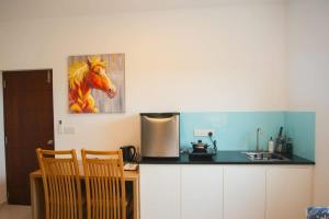 a kitchen with a painting of a horse on the wall at Beachfront Bliss Ocean Views & Sunset Views 