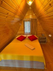 a bedroom with a bed in a wooden cabin at Cozy Home Buknari in Buknari