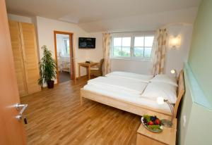 a bedroom with a bed and a table with a bowl of fruit at Boutique Hotel Toso Genussreich in Leutschach +184 photos