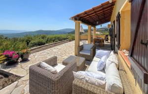 a patio with wicker furniture on a stone patio at Villa Pisicne in Mons