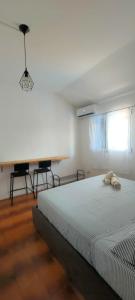 a white bedroom with a bed and a window at B&B Aut in Fiore in Ravenna
