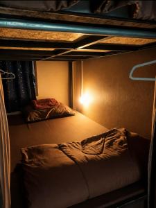 a room with two bunk beds with a light at Sharky's Hostel in Pai