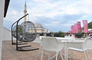 a swing chair sitting on top of a roof at Juna's Hotel in Prizren