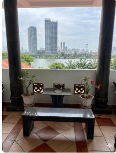 a bench in a room with a view of a river at Stargazer Hotel in Danang
